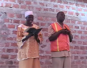 Hannington and a Muslim lady reading the story of the Good Samaritan.