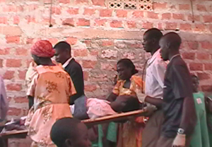 SEVO members carrying off a mock victim on homemade stretcher.